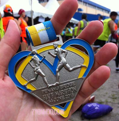 The finisher medal, which says "PENANG BRIDGE HAIF MARATHON"